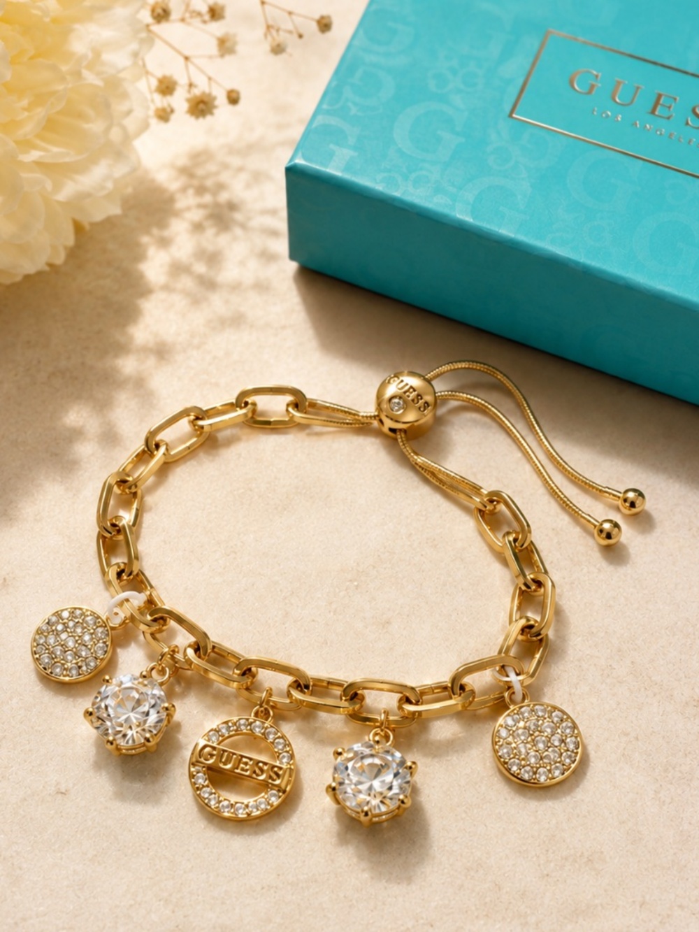 Guess Gold Tone Charm Bracelet Adjustable Bolo Closure Crystal Charms NWT Boxed